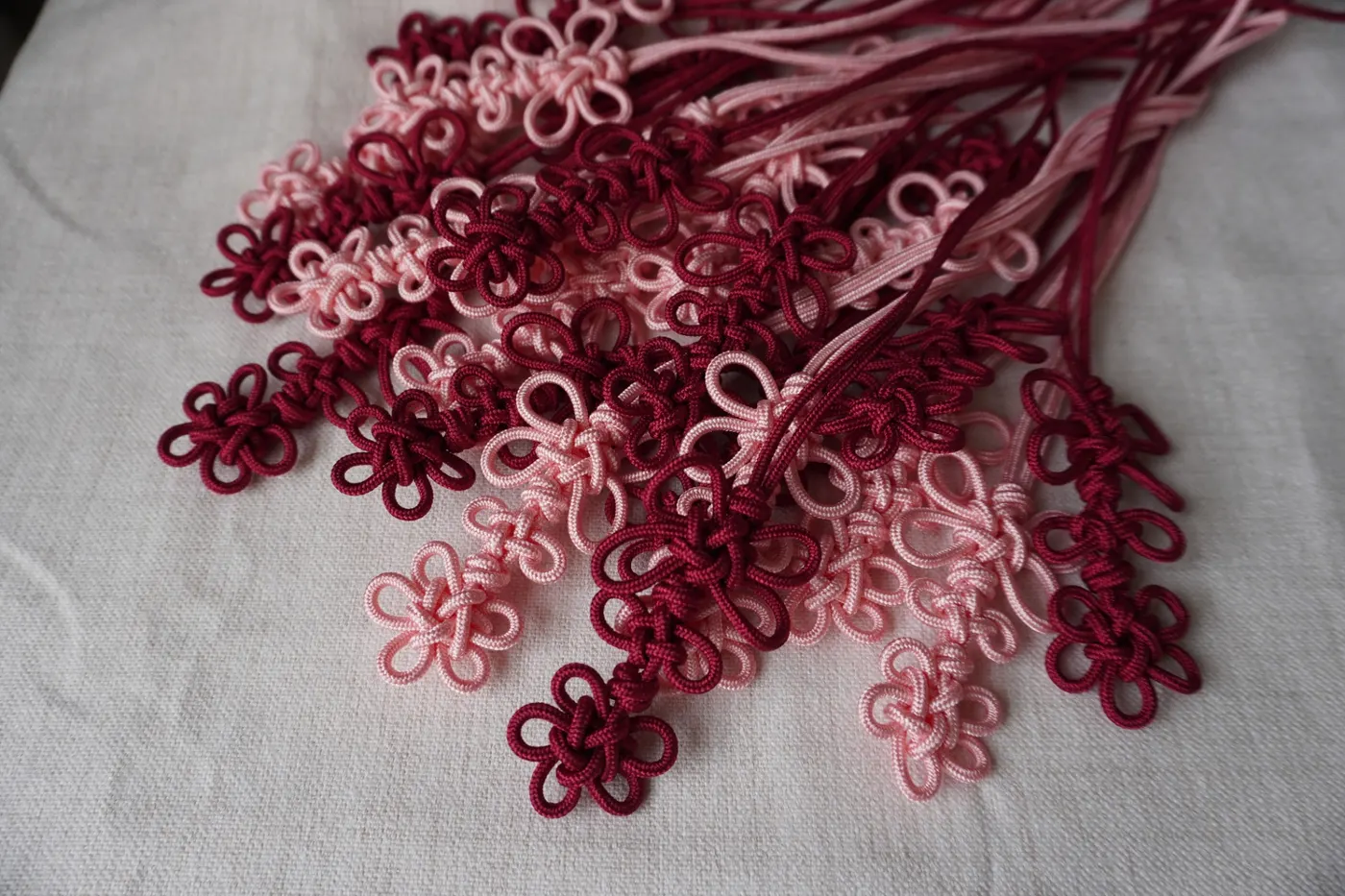 Handcrafted maedeup knots prepared in advance for a norigae bag charm workshop.