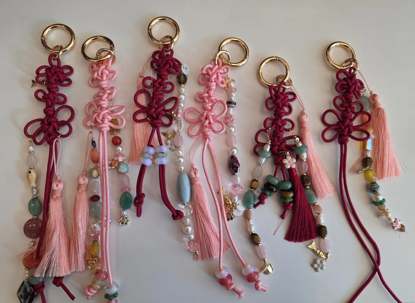 Lineup of completed norigae bag charms and keyrings from a corporate maedeup workshop.